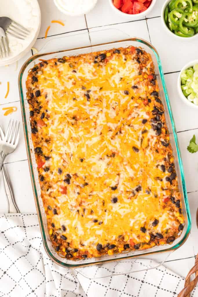finished black bean corn enchilada quinoa casserole with melted cheese in a glass baking dish ready to serve