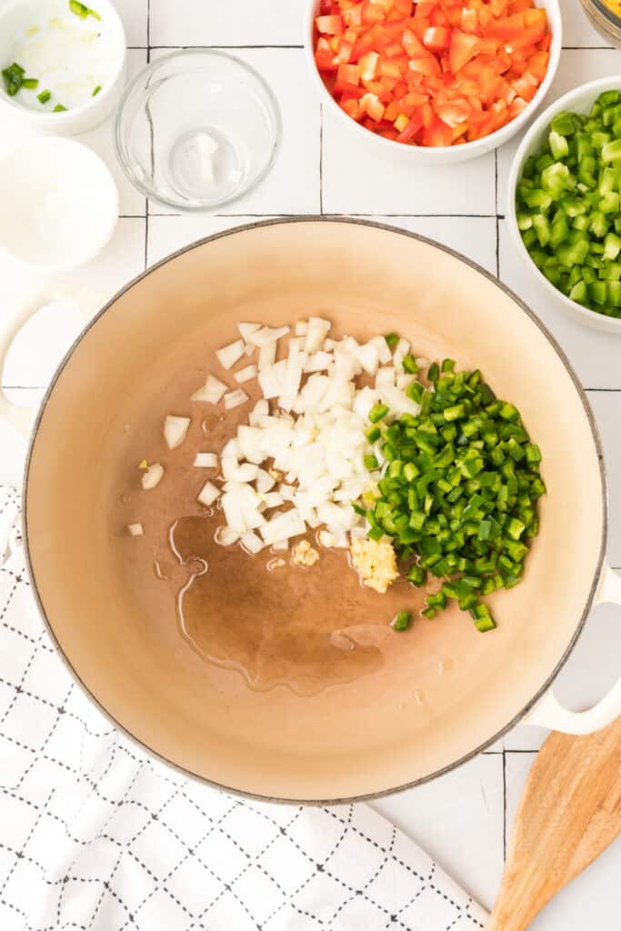 chopped onion, garlic, and jalapeno cooking in a pot for vegetarian enchilada quinoa casserole
