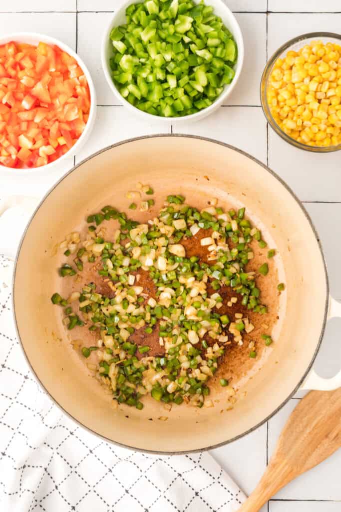 vegetables sautéing together in pot for vegetarian enchilada quinoa casserole