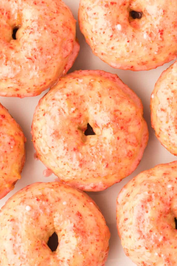 closeup of vanilla cake donuts with fresh strawberry glaze