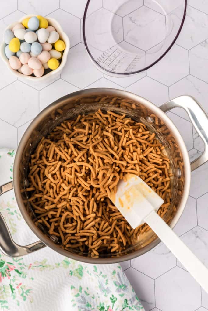 chow mein noodles being stirred into the marshmallow mixture