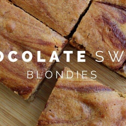 Chocolate Swirl Blondies cut into squares on a cutting board.