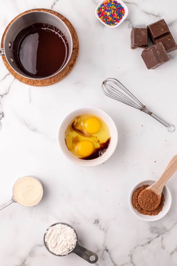 Eggs, vanilla extract, and salt combined in a bowl for the wet ingredients of a Choco-Taco recipe.