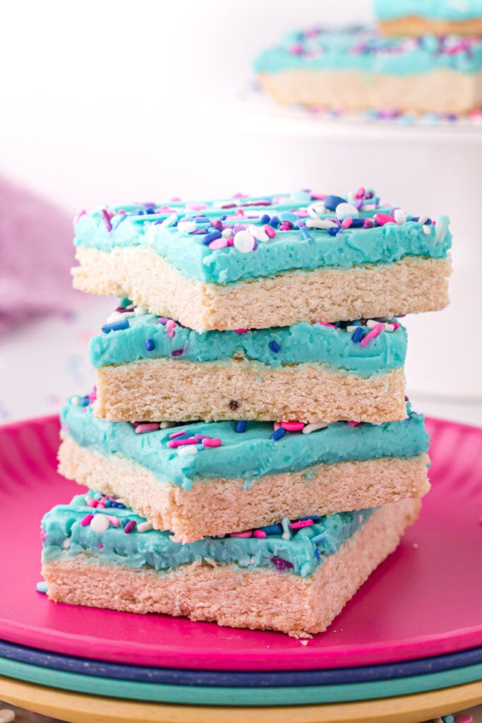four sugar cookie bars stacked on plate