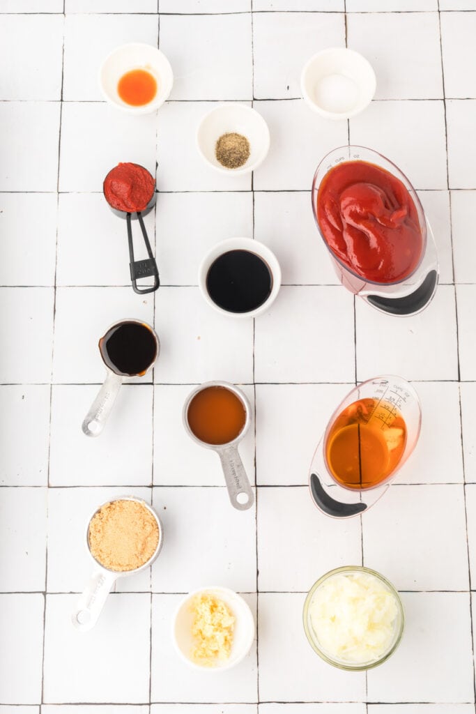 Overhead view of measured BBQ sauce ingredients in small bowls and cups