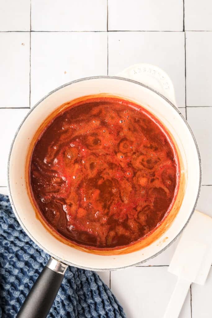 Bourbon BBQ sauce bubbling in saucepan as it simmers
