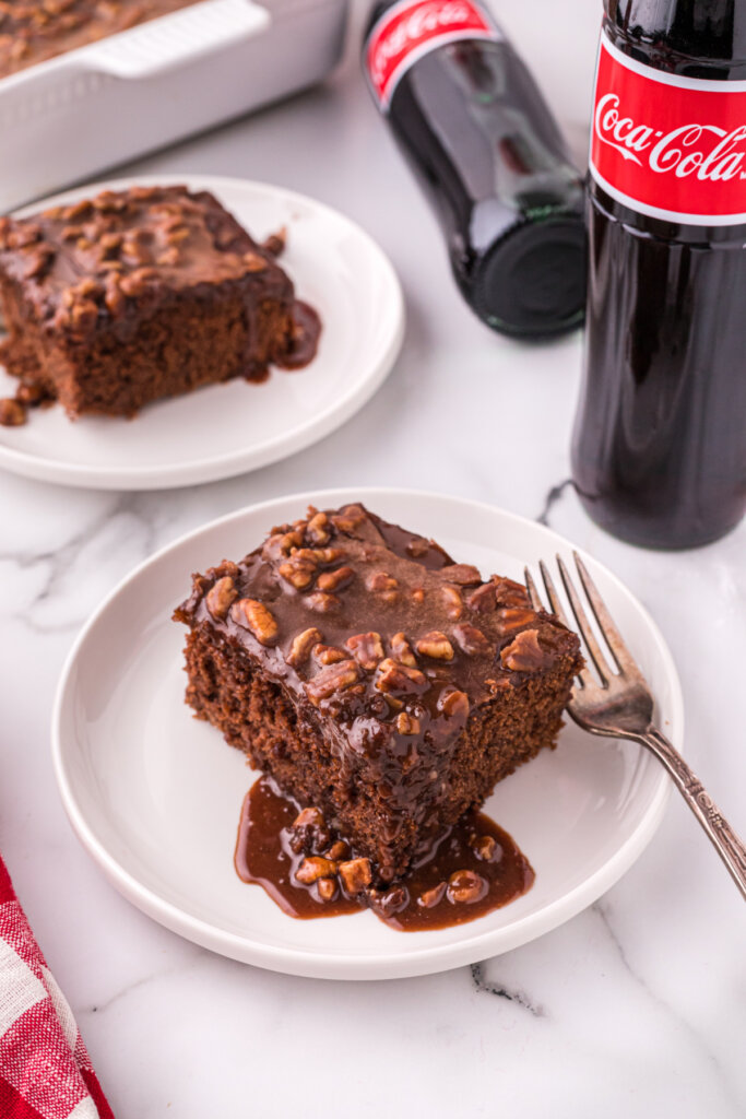 cake slices on plate with coca cola bottles on the right side