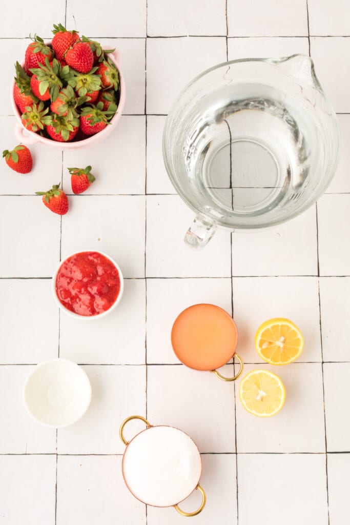 Ingredients for Copycat Red Robin Freckled Lemonade including strawberries, lemon juice, sugar, water, and strawberry topping.
