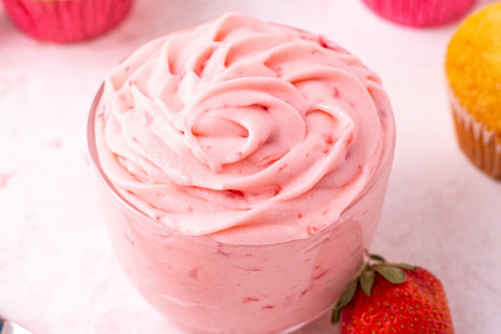 glass jar filled with strawberry buttercream frosting