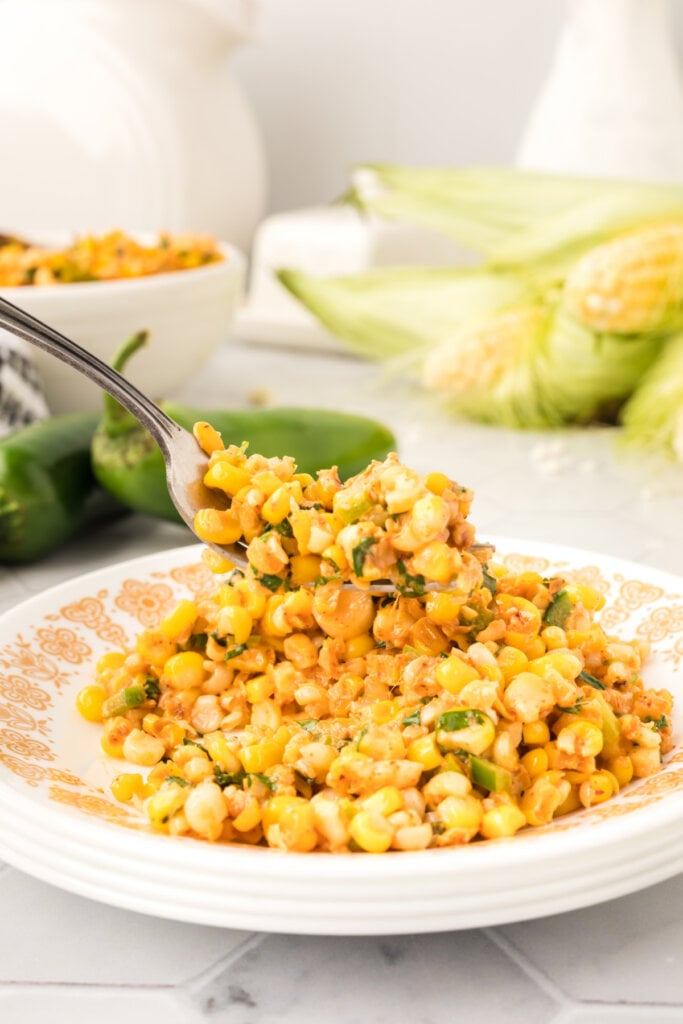 fork scooping mexican street corn salad off plate