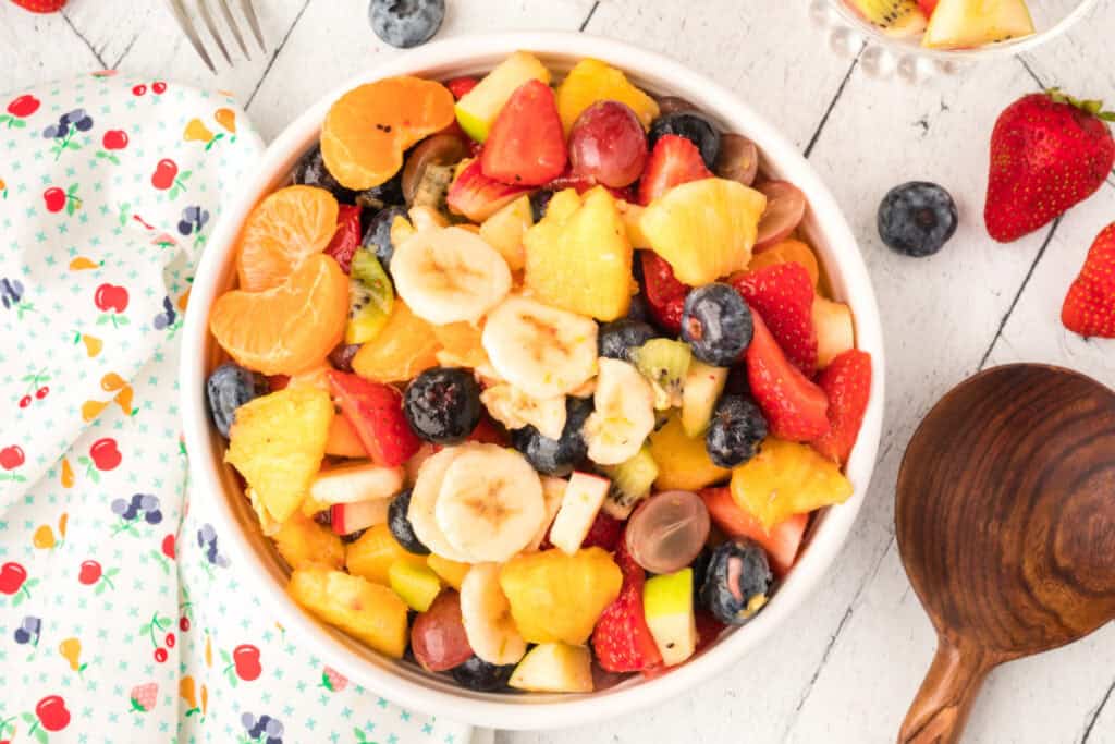 easy fruit salad with dressing in white bowl