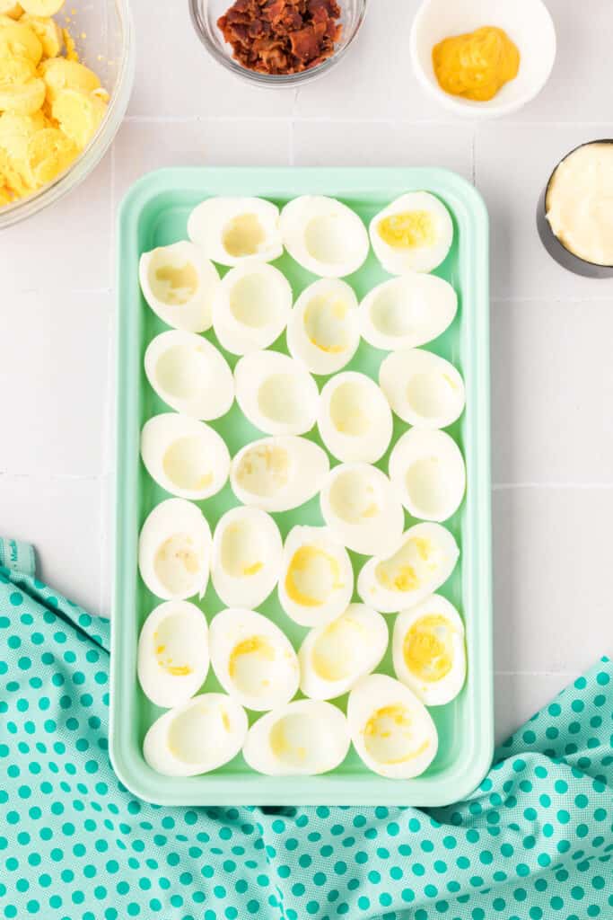 Peel the hard-cooked eggs and cut in half lengthwise.