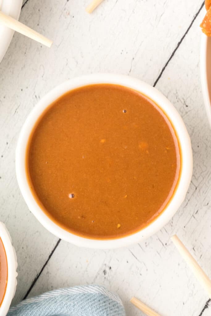 small white bowl filled with thai peanut sauce
