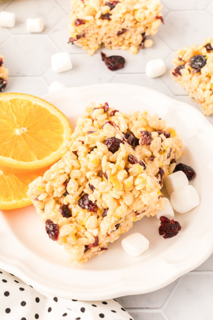 cranberry orange rice crispy treats on white plate