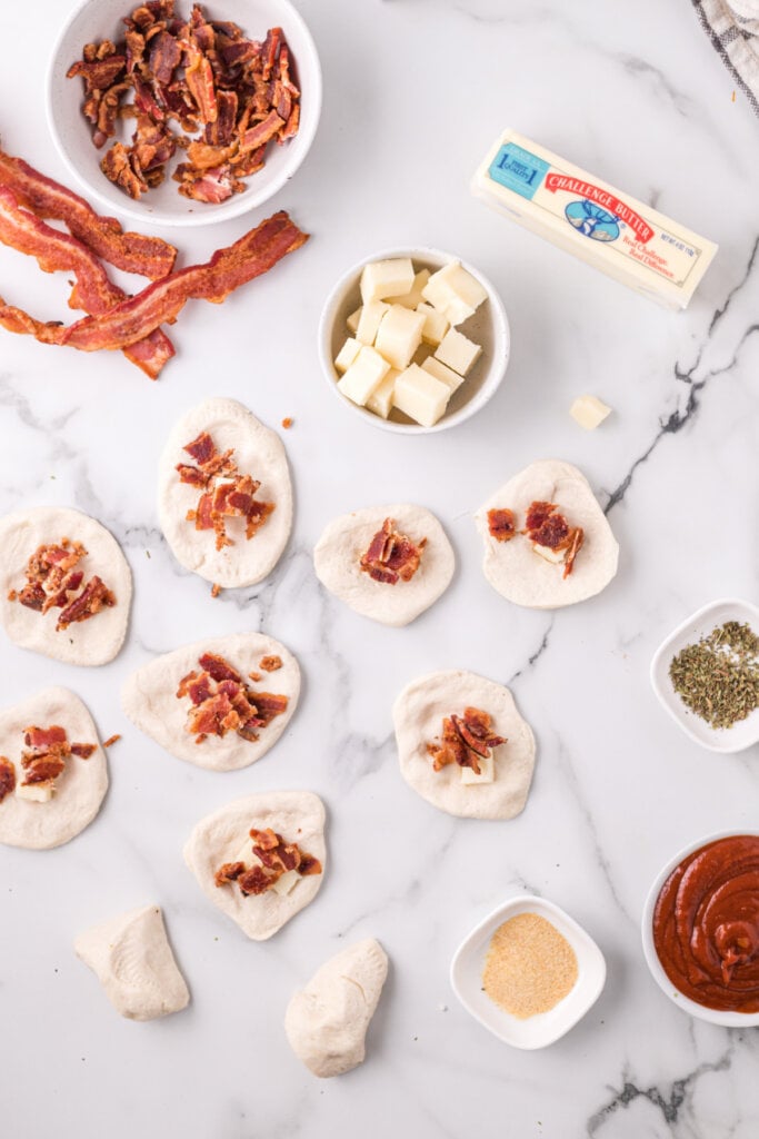 bacon added to the center of each biscuit dough