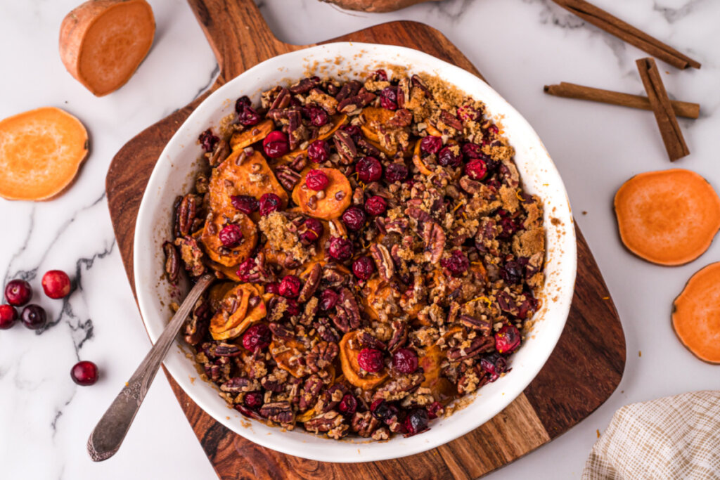 cranberry pecan sweet potato casserole dish with a spoon in it