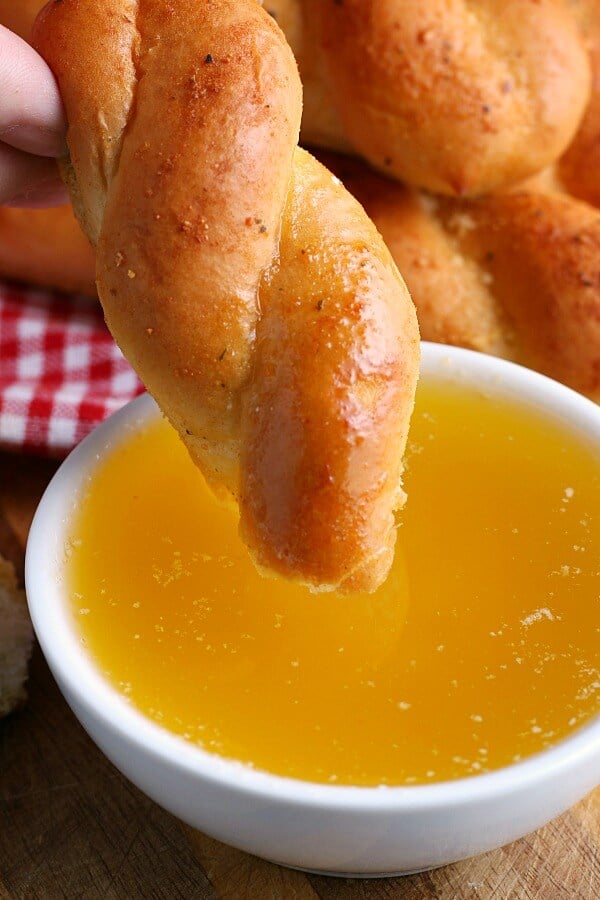 bread being dipped into garlic butter recipe
