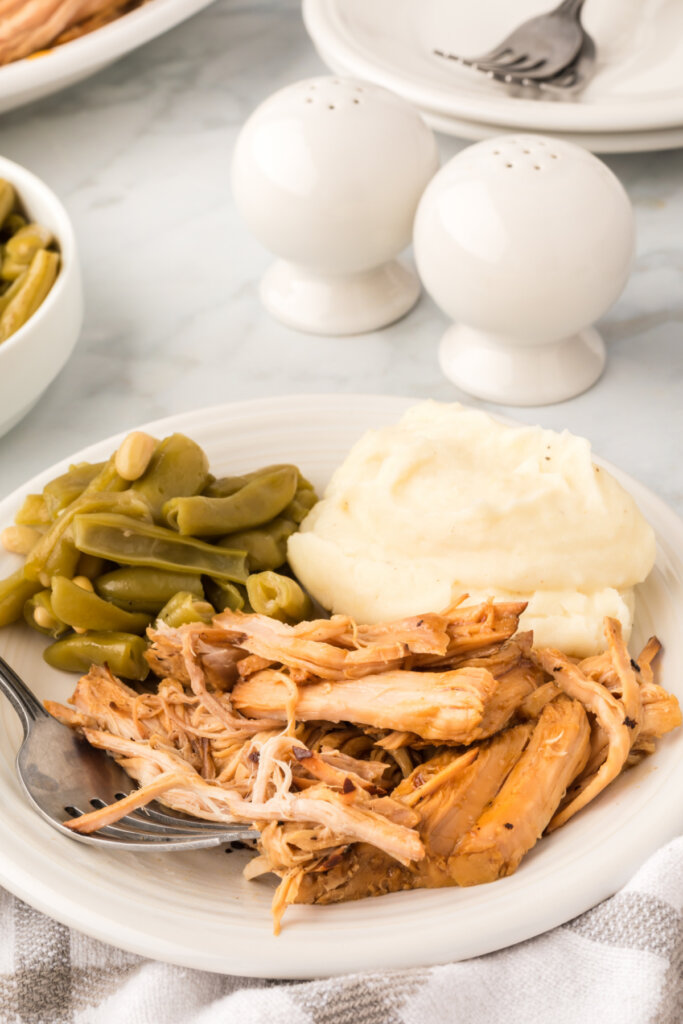 dinner plate with pork roast, mashed potatoes, and green beans