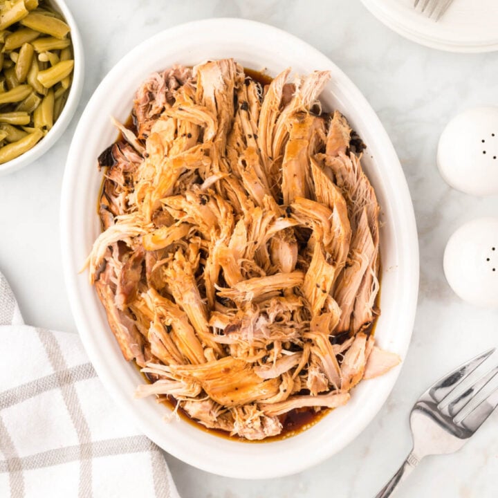 slow cooker pork roast in white serving plate