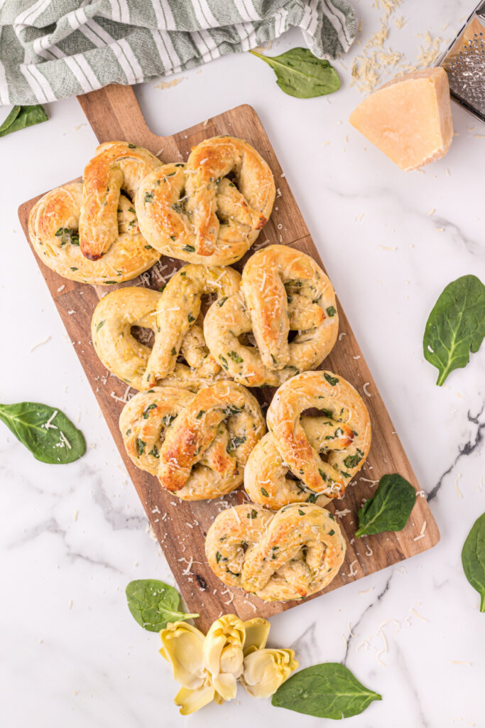 spinach artichoke pretzels on wooden cutting board