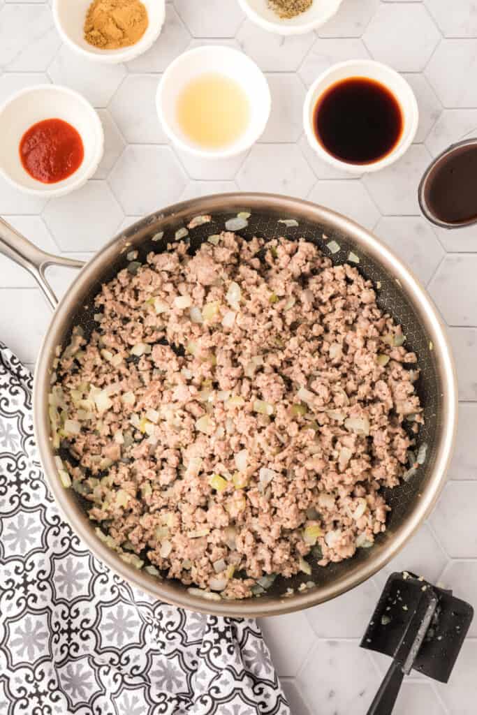 cooked ground pork and onions in a skillet for Asian Pork Lettuce Wraps