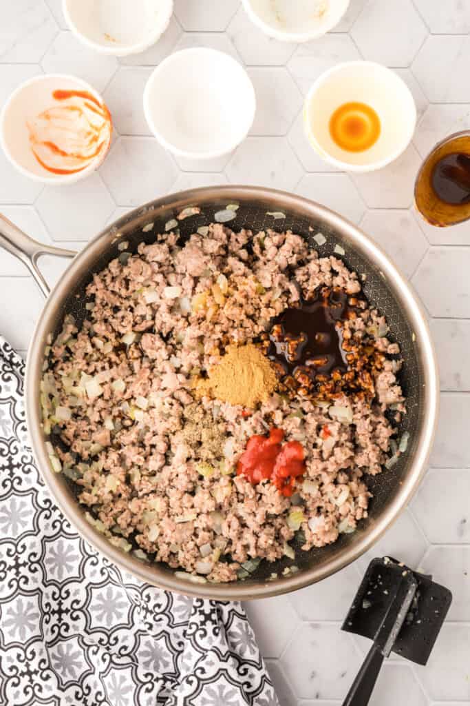 ground pork mixture with sauces and seasonings added in a skillet for Asian Pork Lettuce Wraps