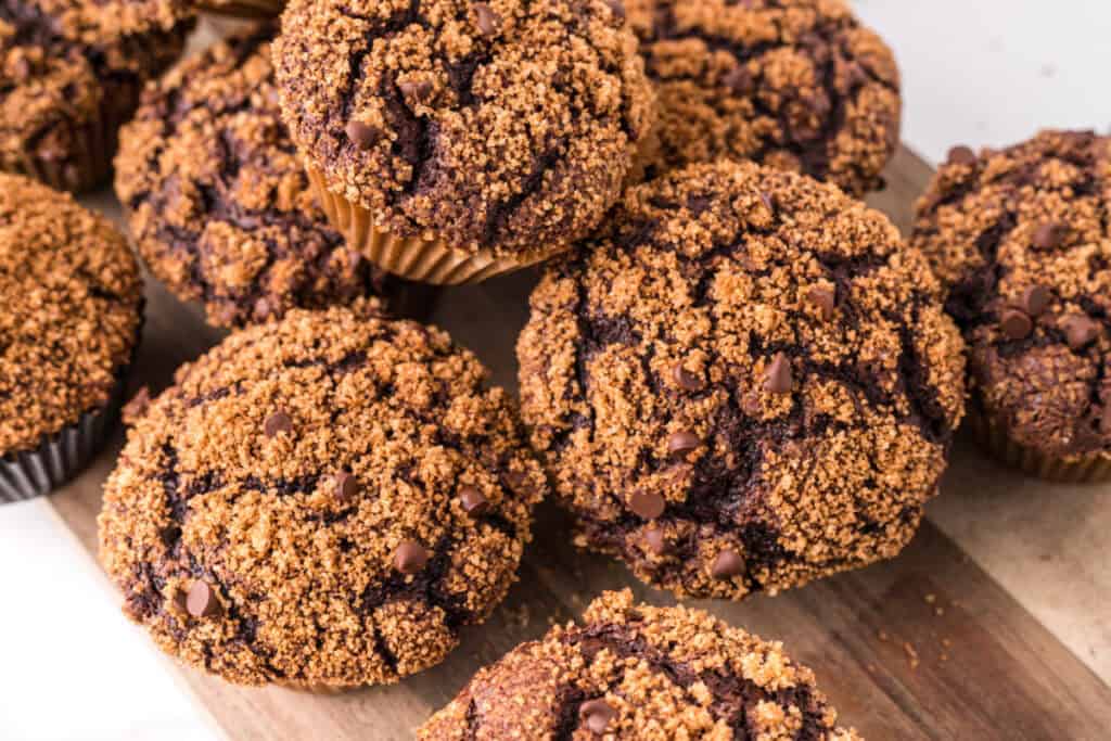 Chocolate Streusel Muffins stacked on a wooden serving board