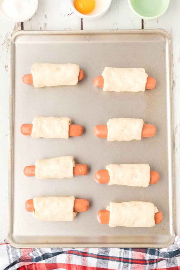 wrap the hot dogs in dough