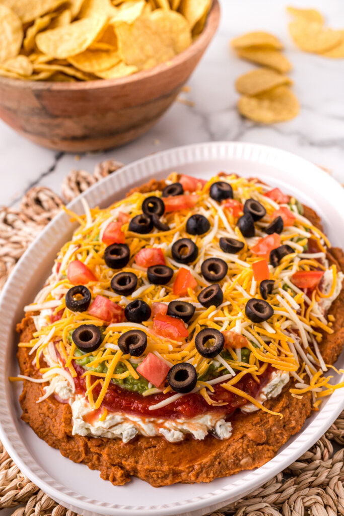 layered bean dip on platter