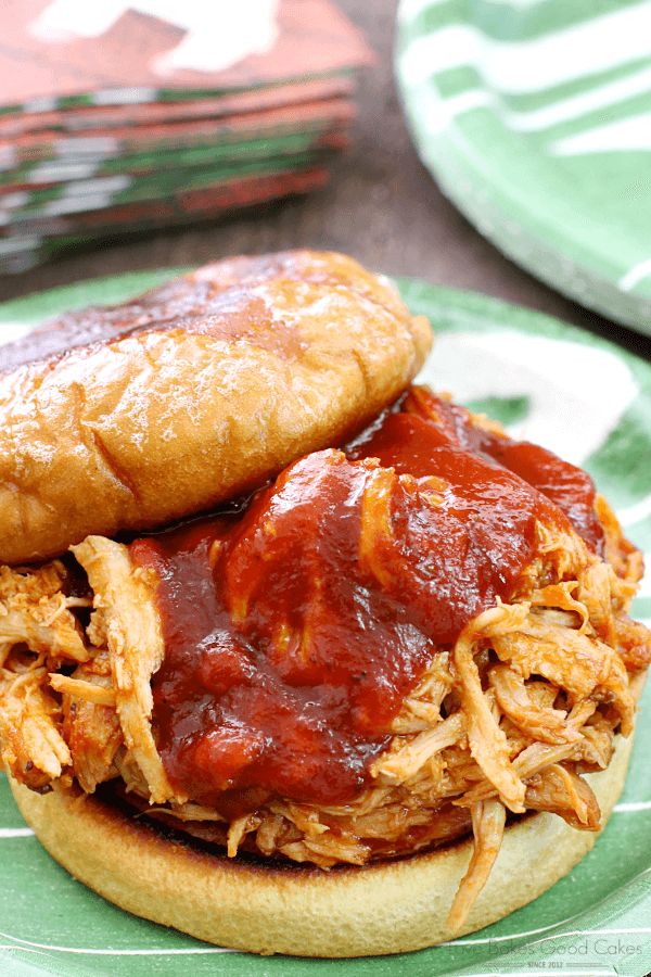 Slow Cooker BBQ Pulled Pork Sandwich close up on a plate with the top off.