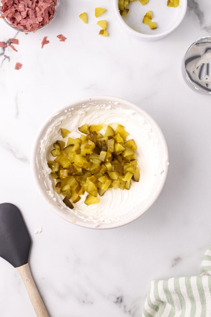 Chopped dill pickles added on top of the cream cheese mixture