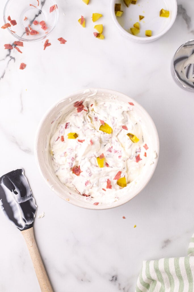 Dip fully mixed together, showing creamy texture with visible pickle and beef bits