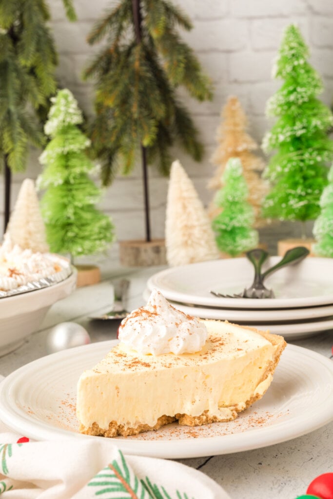 slice of eggnog pie on plate with winter scene in background