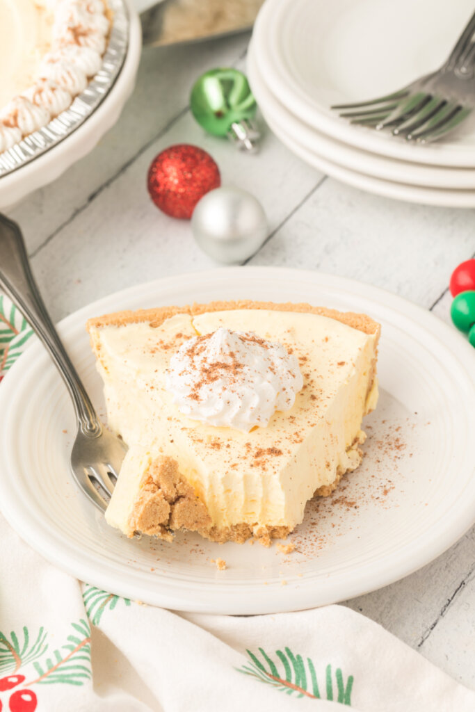 slice of eggnog pie on plate with bite on fork