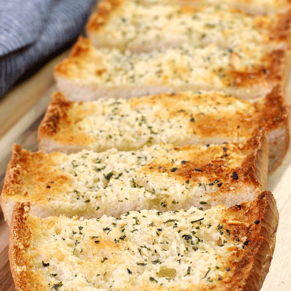BEST Garlic Bread sliced on a cutting board.