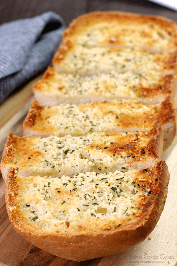 BEST Garlic Bread sliced on a cutting board.