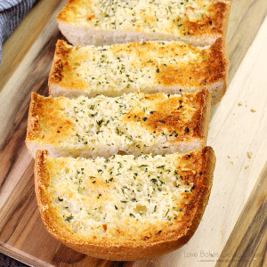 BEST Garlic Bread sliced on a cutting board.