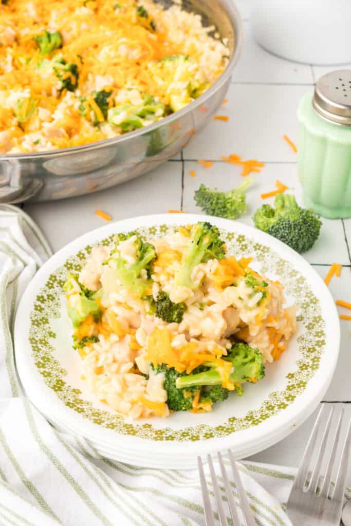 Plate of Cheesy Chicken Broccoli Rice Skillet served with broccoli, chicken, rice, and melted cheddar cheese