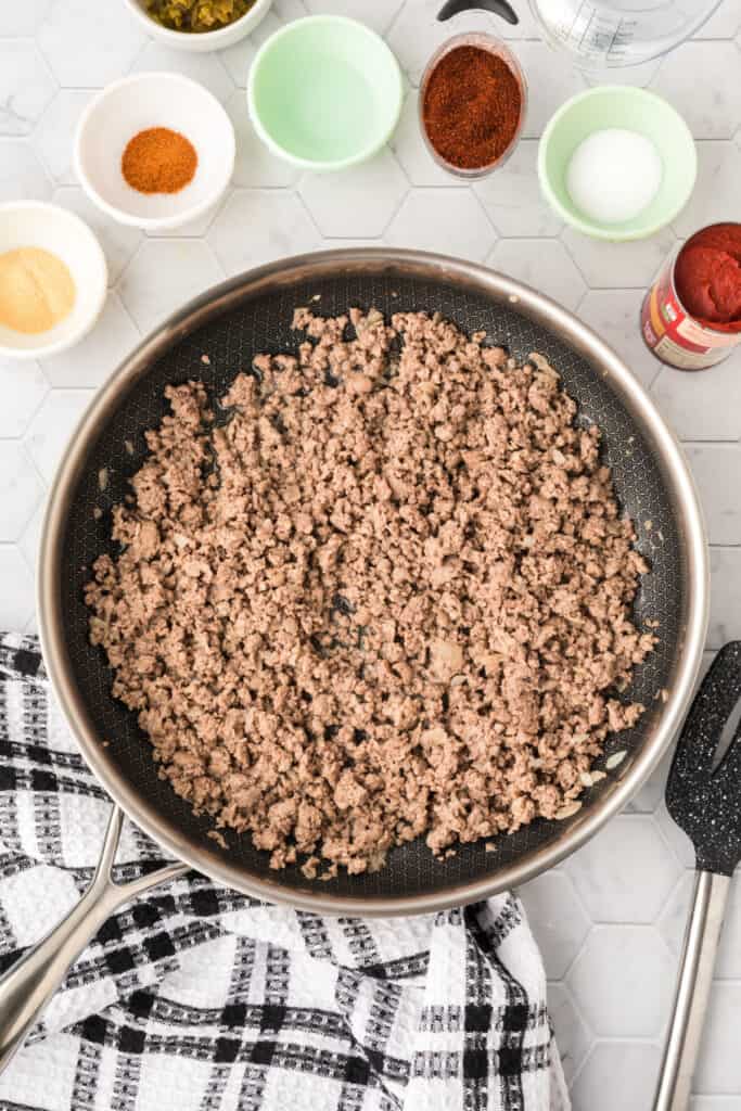 Ground beef and onion browned in a large skillet during preparation for Chili Cheese Burrito filling.
