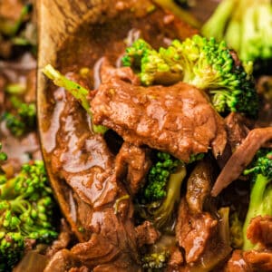 Square image of beef and broccoli served in a white bowl