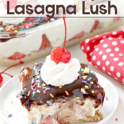 No-Bake Banana Split Lasagna Lush on a white plate with cherries.