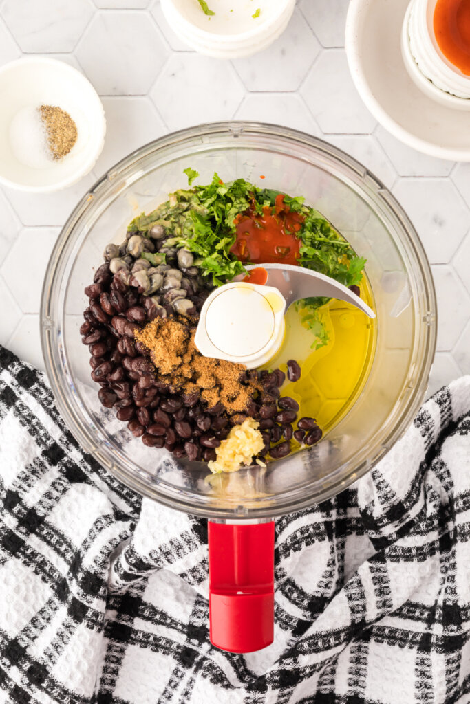 black bean hummus ingredients in food processor bowl