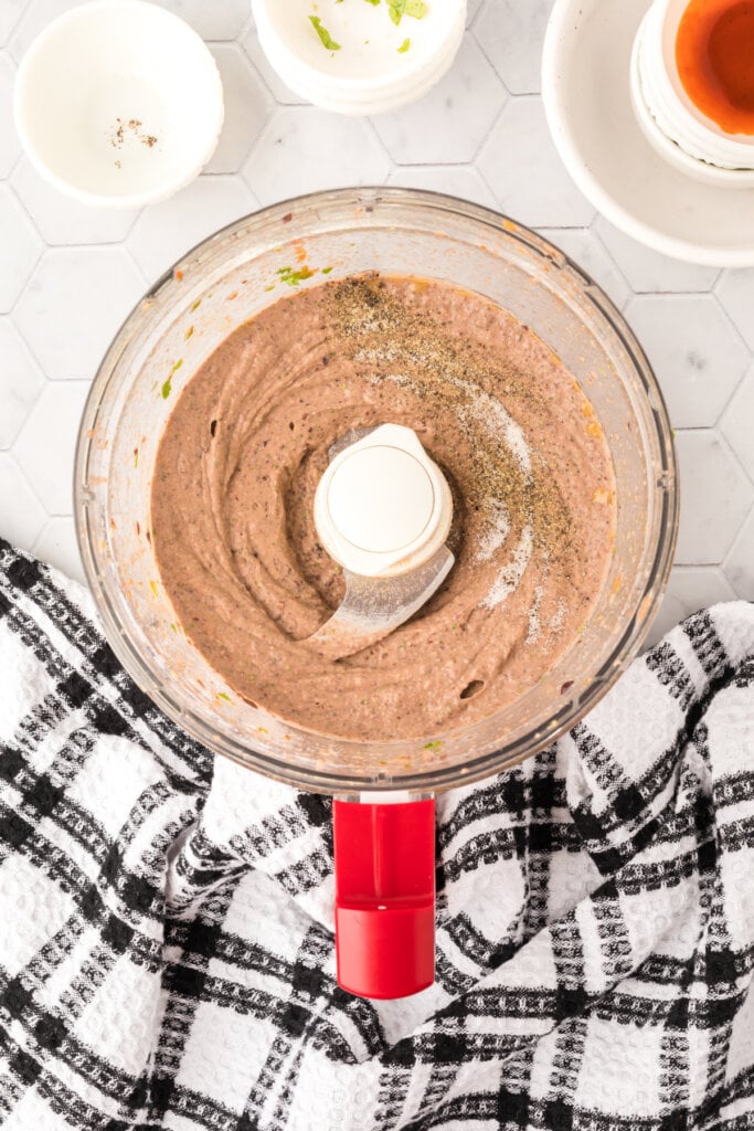 black bean hummus that has been blended in food processor bowl