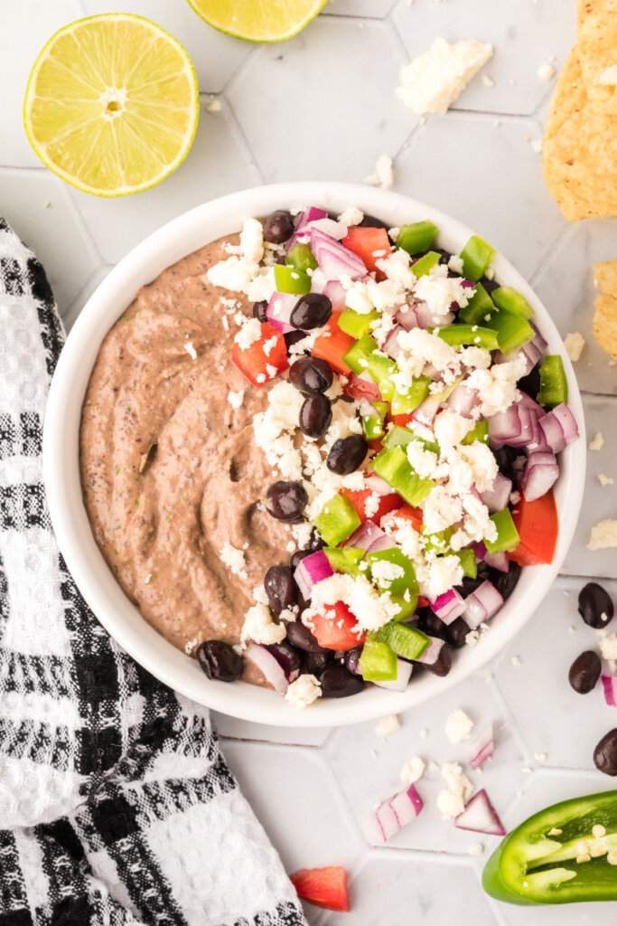 looking down into a bowl of loaded mexican black bean hummus