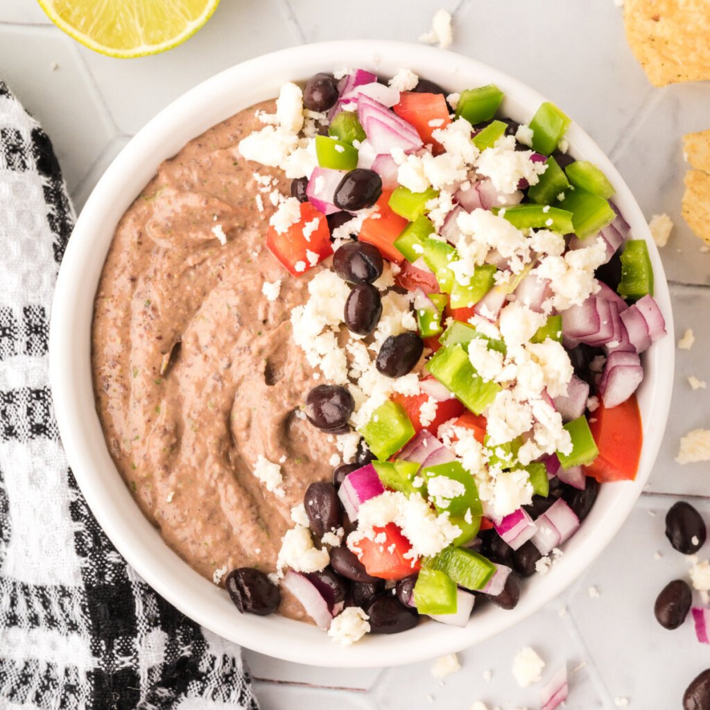 loaded mexican black bean hummus in white bowl