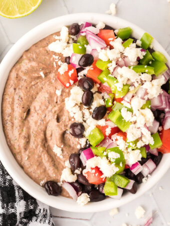loaded mexican black bean hummus in white bowl