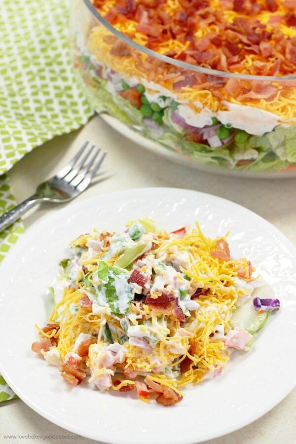 This 7 Layer Salad is the perfect addition to any meal or potluck. With layers of veggies, a tangy dressing, cheese, and bacon, this will be a new favorite!