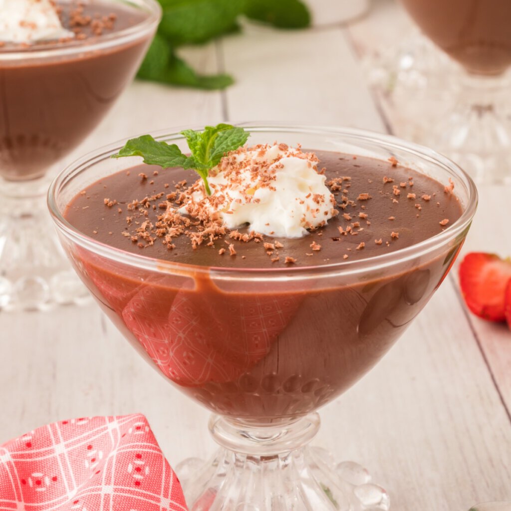 chocolate pudding garnished with whipped cream and mint