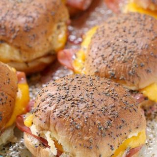 These easy crowd-pleasing Ham and Cheese Sliders are the perfect accompaniment to a bowl of soup - or serve them up on game day - for a winning recipe, everyone will love!