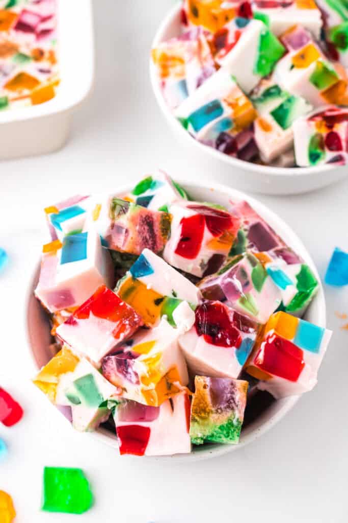 Bowl of Broken Glass Jello dessert cubes with colorful gelatin pieces in creamy milk gelatin